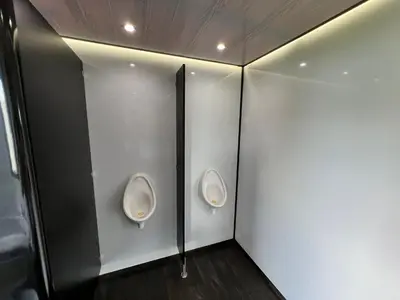 a bathroom with two urinals on the wall at IntentsGP @ Isle of Man TT, IOMTT in Douglas