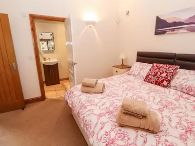 a bedroom with a bed with two towels on it at The Hayloft in Keswick