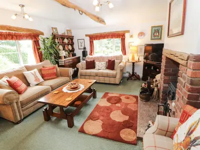a living room with a couch and a table at Fell Cottage in Wigton