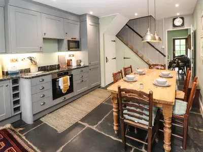 a large kitchen with a wooden table and chairs at 1 Field Foot Cottage in Ambleside