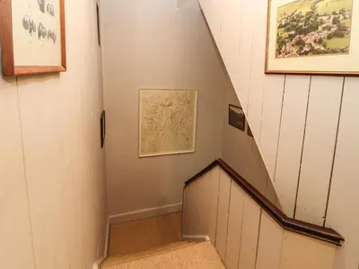 a staircase in a house with pictures on the wall at 1 Field Foot Cottage in Ambleside