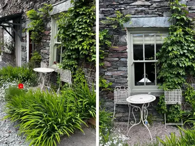 a table and chairs in front of a building at 1 Field Foot Cottage in Ambleside