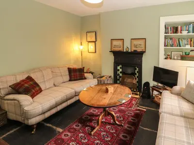 a living room with a couch and a coffee table at 1 Field Foot Cottage in Ambleside
