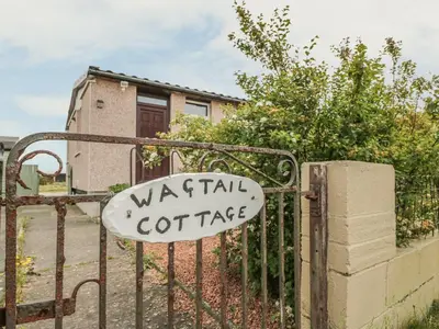 a sign on a gate in front of a house at Wagtail Cottage in Mainsriddle