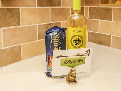 a bottle of alcohol and a cat figurine on a counter at The Cottage at Graysondale Farm in Cockermouth