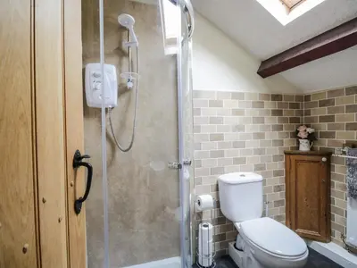a bathroom with a shower with a toilet at The Cottage at Graysondale Farm in Cockermouth