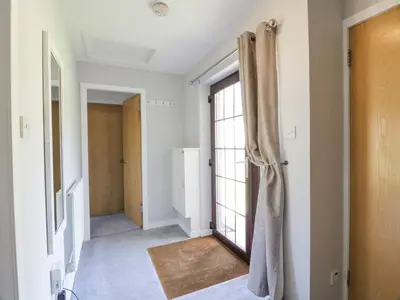 an empty hallway with a door and a window at Brunston Castle Lodge in Girvan