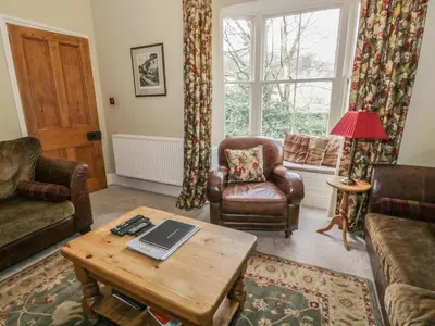 a living room with a laptop on a coffee table at Rowan Cottage in Grasmere