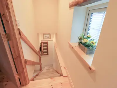 a staircase in a house with a window at Rose Cottage in Crosby