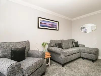 a living room with a couch and a chair at Andra Ghyll in Keswick