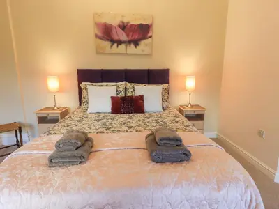 a bedroom with a bed with two towels on it at Greta Mill in Keswick