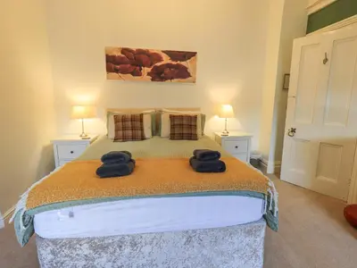 a bedroom with a bed with two towels on it at Greta Mill in Keswick