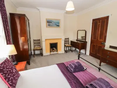 a bedroom with a bed and a fireplace at Pelham House in Keswick