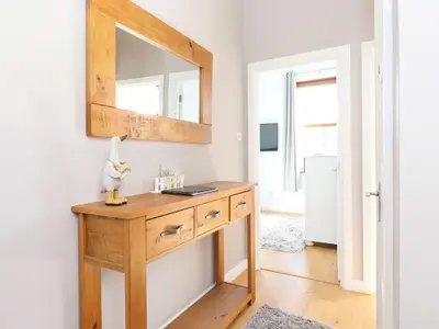 a bathroom with a wooden dresser with a mirror at Sky View in Keswick