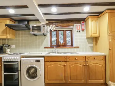 a kitchen with a sink and a washing machine at The Old Barn in Nether Wasdale