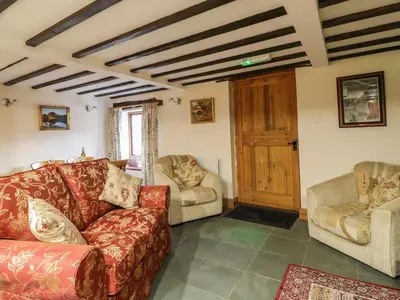 a living room with a couch and two chairs at The Old Barn in Nether Wasdale