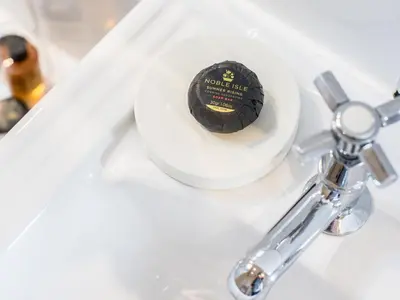 a close up of a toothbrush holder on a bathroom sink at Reflection in Canonbie
