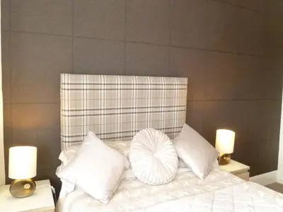 a bed with white pillows and two lights on tables at Greenlaw Guest House in Gretna Green