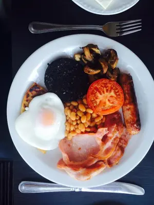 a plate of breakfast food with an egg and beans at Craignelder Hotel in Stranraer