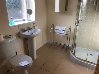 a bathroom with a shower and a toilet and a sink at Irton Hall in Eskdale