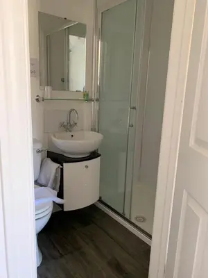 a bathroom with a toilet and a sink and a shower at Littletown Farm Guest House in Keswick