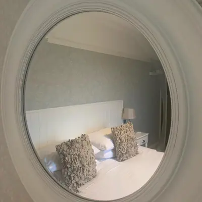 a reflection of a bed in a mirror at Littletown Farm Guest House in Keswick