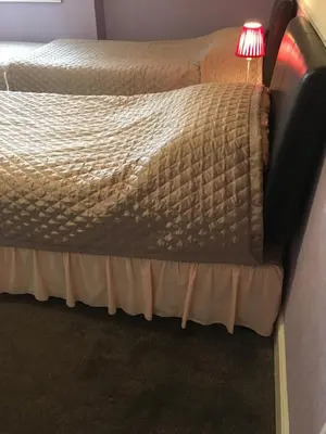 a bed in a room with a lamp on it at Adelphi Guest House in Douglas