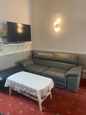 a living room with a couch and a table at Adelphi Guest House in Douglas