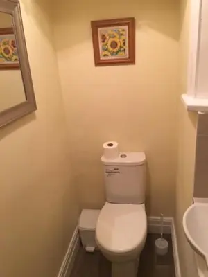a small bathroom with a toilet and a sink at Lincoln Guest House in Keswick