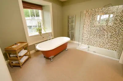 a bathroom with a bath tub and a shower at Eltermere Inn in Elterwater