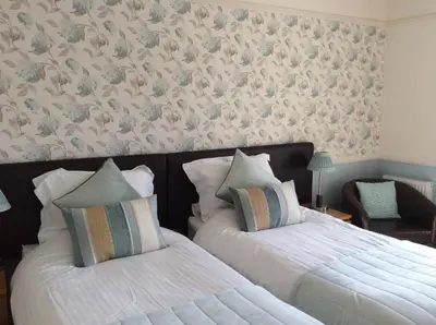 two beds sitting next to each other in a bedroom at Douglas House in Castle Douglas