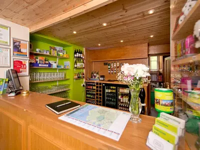 a shop with a counter with a vase of flowers on it at YHA Langdale in Ambleside