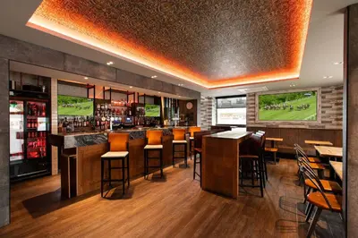 a bar with chairs and tables in a restaurant at Royal Hotel in Cumnock