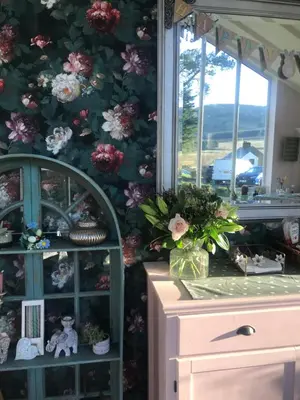 a room with a wall covered in flowers at Netherdene Country House Bed & Breakfast in Troutbeck