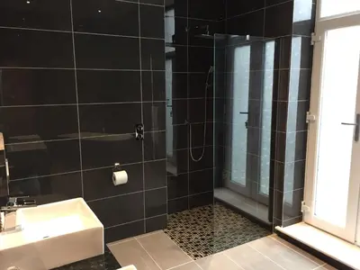 a bathroom with a shower and a sink at Halvard Hotel in Douglas
