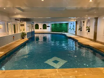 a large swimming pool in a hotel room at Washington Central Hotel and Sleepwell Inn in Workington