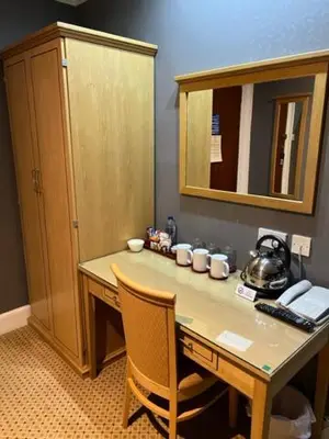 a room with a desk with a tea kettle on it at Caledonian Hotel in Dumfries