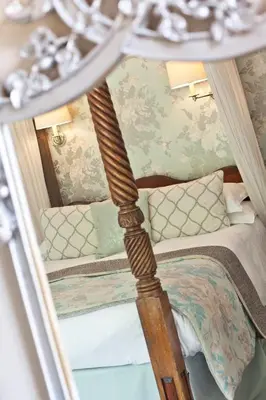 a bed with a wooden post in a room at Bridge Hotel in Buttermere