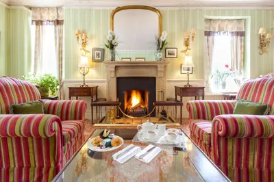 a living room with two couches and a fireplace at Bridge Hotel in Buttermere