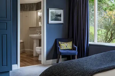 a bedroom with a bathroom with a sink and a toilet at Langdale Hotel & Spa in Ambleside