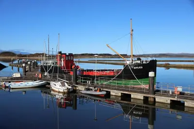 a boat docked at a dock with boats in the water at Marina Studio in Irvine