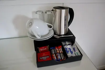 a black shelf with a coffee pot on top of it at Harbourside Hotel in Irvine