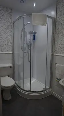 a shower stall in a bathroom with a toilet at Lindean Guest House in Dumfries