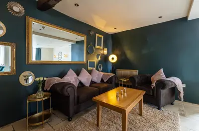 a living room with two couches and a mirror at The Pennington Hotel in Ravenglass