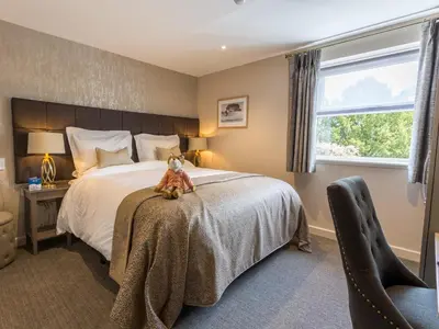 a teddy bear sitting on a bed in a bedroom at The Sally in Carlisle