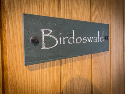 a sign on a wooden door with the word blubbicked at The Sally in Carlisle