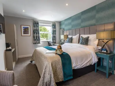 a bedroom with a bed with a teddy bear sitting on a blanket at The Sally in Carlisle