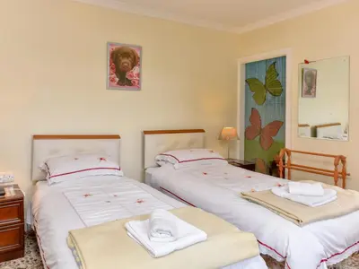 two beds in a room with towels on them at The Warren Guest House in Carlisle