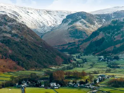 a valley in the mountains with a snow covered mountain at Castle Howe in Rosthwaite