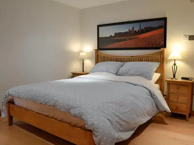 a bedroom with a bed with a picture on the wall at Castle Howe in Rosthwaite